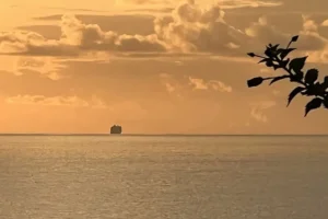 Cruise ship off the coast of Rapa Nui at sunset.