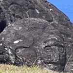 An ancient petroglyph depicting Make-Make, carved into volcanic rock overlooking the ocean on Easter Island.